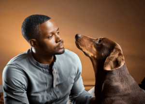 Stressed man and anxious dog looking up at him